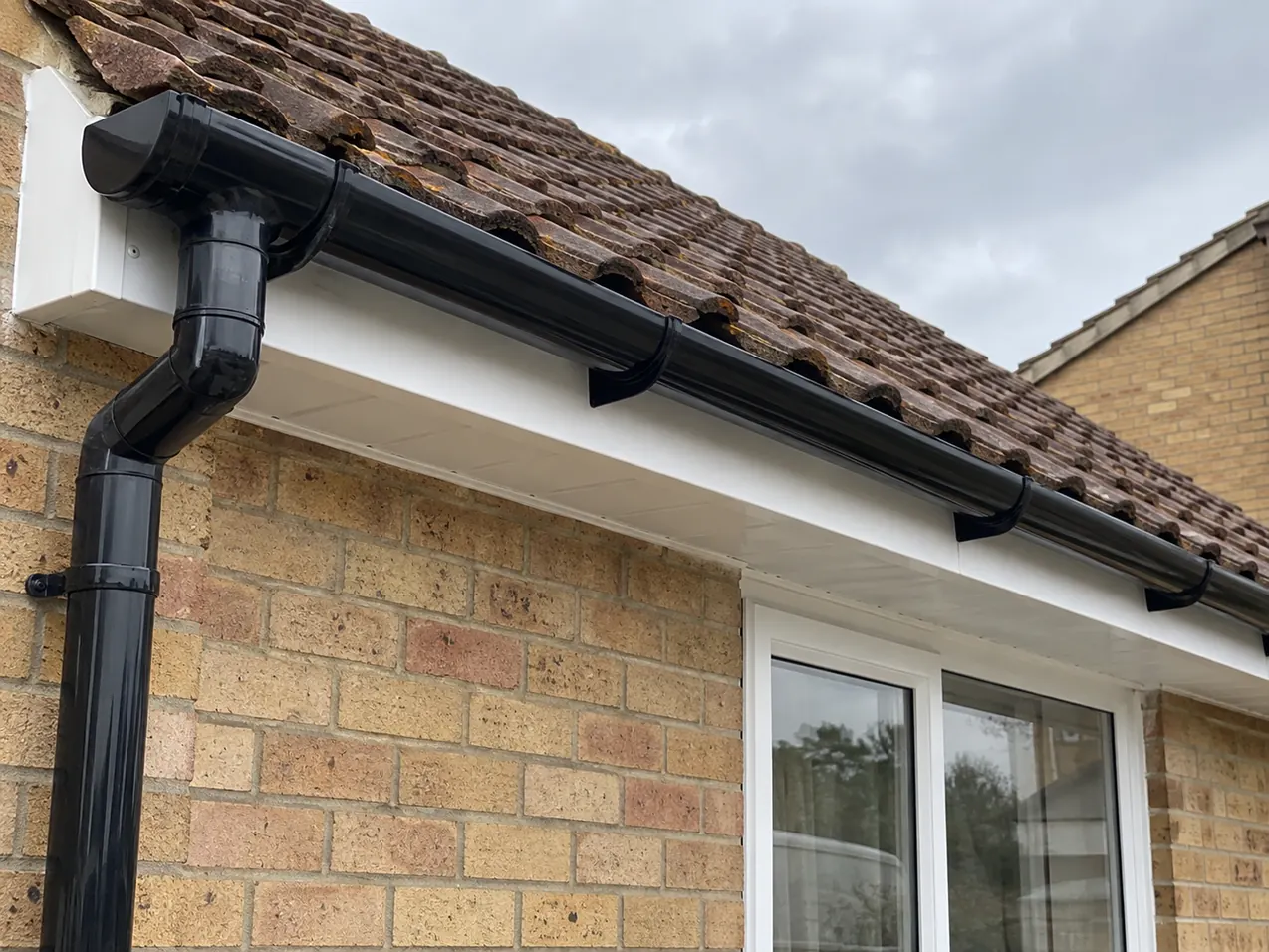 New black guttering with white fascia and soffit boards